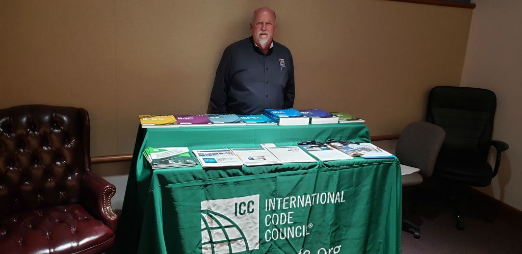 Mark Roberts Lead Sr. Regional Manager ICC Governement Relations shows off many code books and standards at the American Wood Council Training held in Pensacola